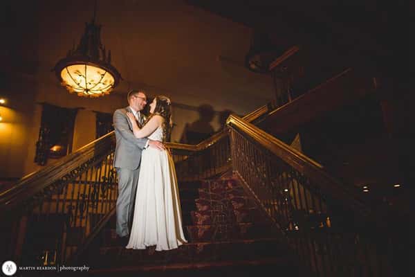 a couple standing on stairs