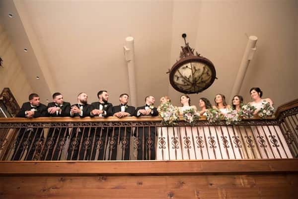 wedding party standing on balcony