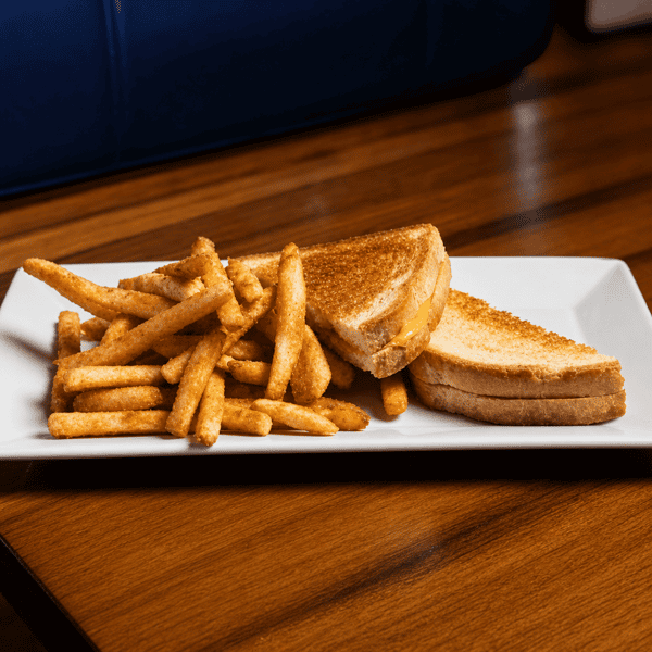 Grilled cheese sandwich served with a side of french fries