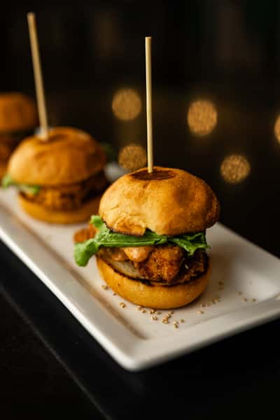 The Bang Bang sliders. Fried chicken, lettuce, pickles, toasted sesame seeds, and bang bang sauce.