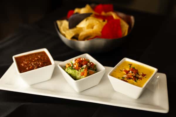 Our trio! Golden queso, fresh guacamole, red salsa, and chips.