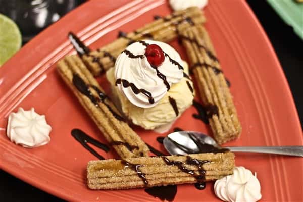 Churros with ice cream and chocolate drizzle