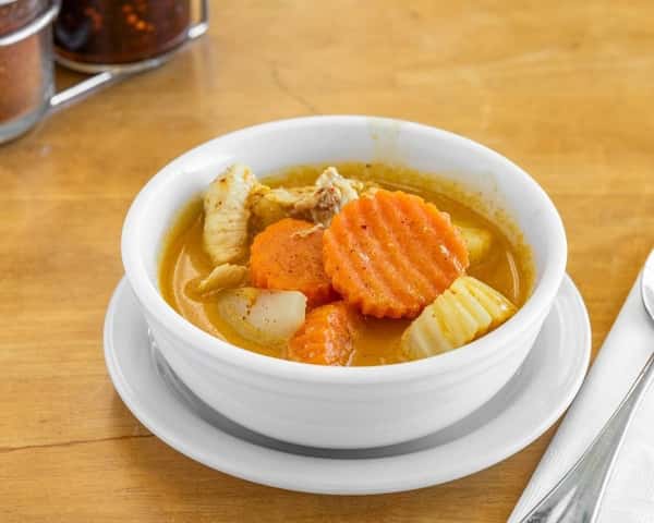 Bowl of Thai yellow curry with chicken, carrots, and potatoes in a creamy coconut curry sauce—mildly spiced and perfect with a side of jasmine rice.