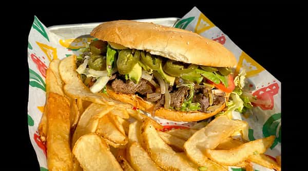 A torta sandwich with steak, avocado, jalapeños, lettuce, and onions, served with potato wedges.