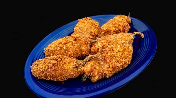 Five breaded and fried jalapeño poppers on a blue oval plate.