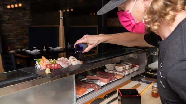 staff member preparing sashimi