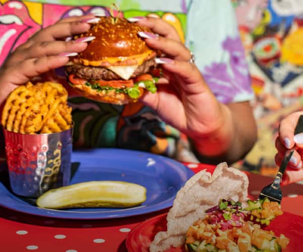 person eating burger at the friendly toast