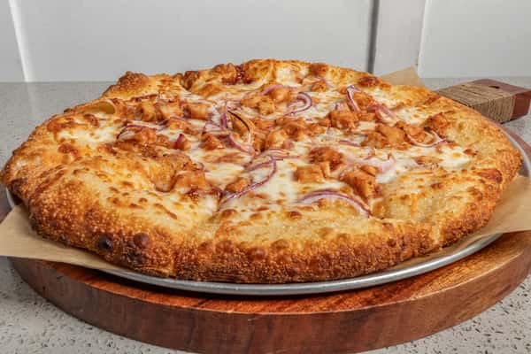 Barbecue chicken pizza topped with tender grilled chicken, red onions, and melted mozzarella on a golden, crispy crust.