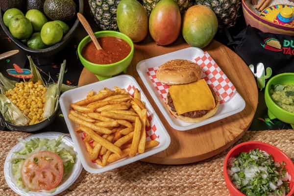 Classic cheeseburger with a slice of cheddar cheese, served with crispy golden French fries, guacamole, salsa, and fresh vegetables, against a backdrop of tropical fruits.
