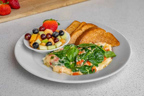 Veggie omelet with fruit and toast