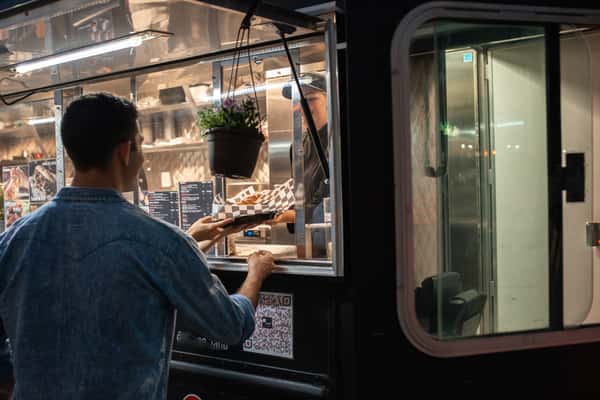 customer getting order from the food truck