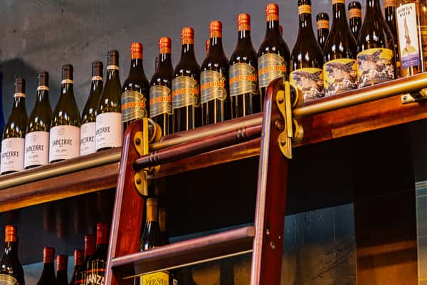 top shelf with bottles of wine