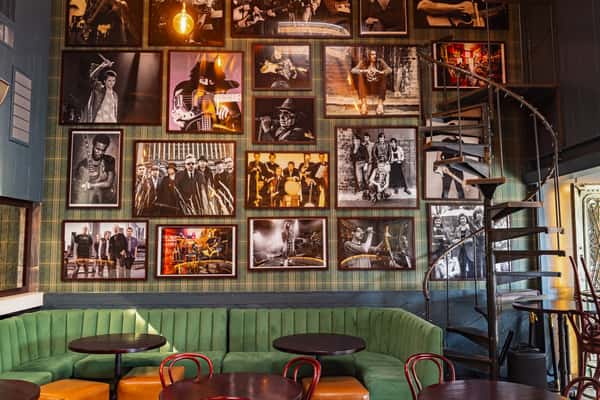 wall of framed photos of bands