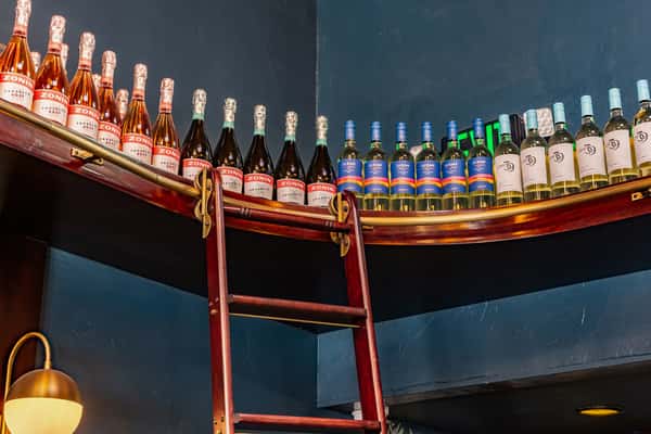 top shelf of wine bottles