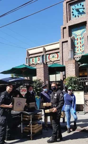 Loading Urth Caffé Lunch Boxes into Police van in front of Urth Downtown