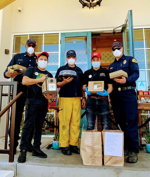 3 Hawthorne Firemen, one with yellow pants, with two Urth employees on Urth South Bay entrance with Urth bags and lunch boxes