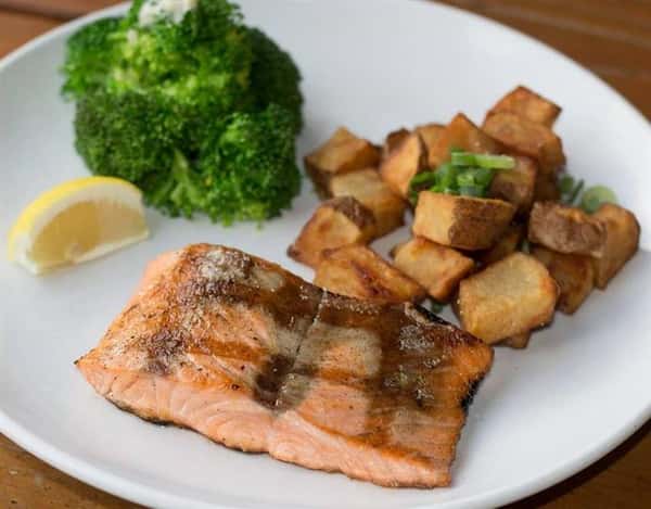 glazed cooked salmon with pottaoes and vegetables