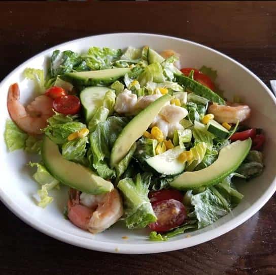 garden salad with shrimp, avocado, cheese and cucumbers