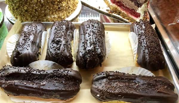 chocolate eclair desserts being displayed