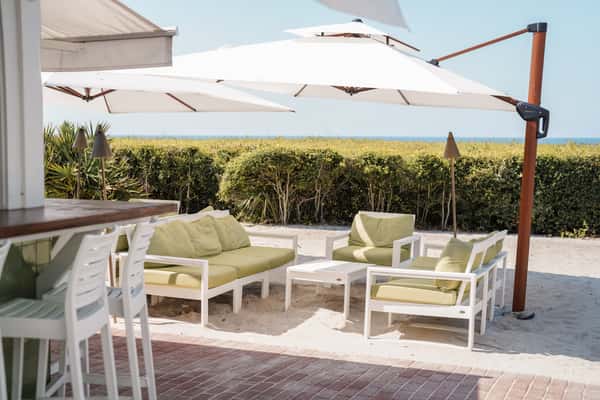 Open-air patio with comfortable seating and ocean views at a coastal dining destination.