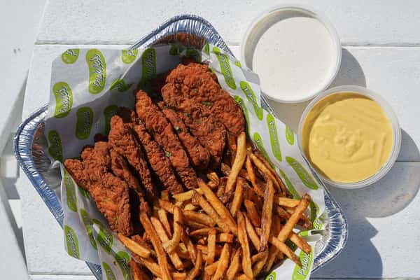 Crispy fried chicken tenders served with golden fries and creamy dipping sauces, perfect for catering and family meals.