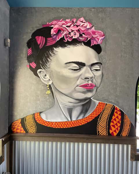 women painting on a wall