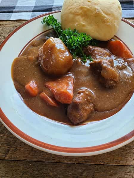 stew with carrots and dinner roll