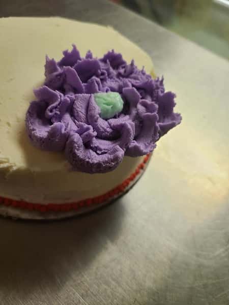 small cake with decorative frosting flower