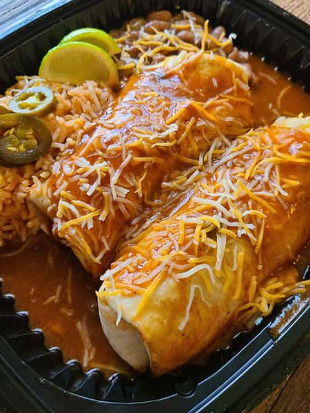 two burritos with rice and lime