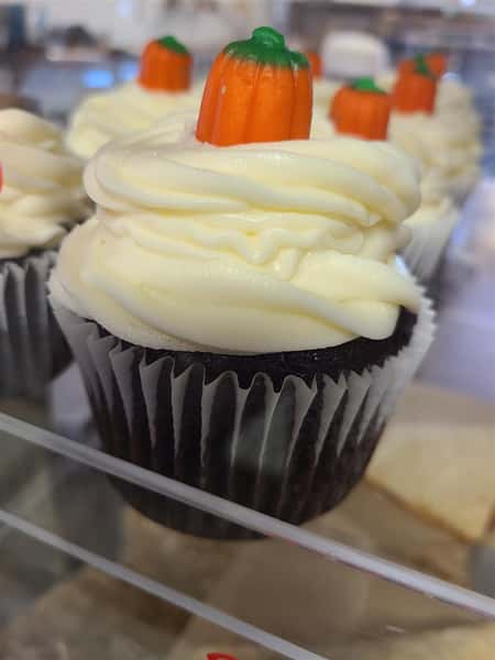 Chocolate cupcakes with a vanilla frosting and a pumpkin candy corn topping