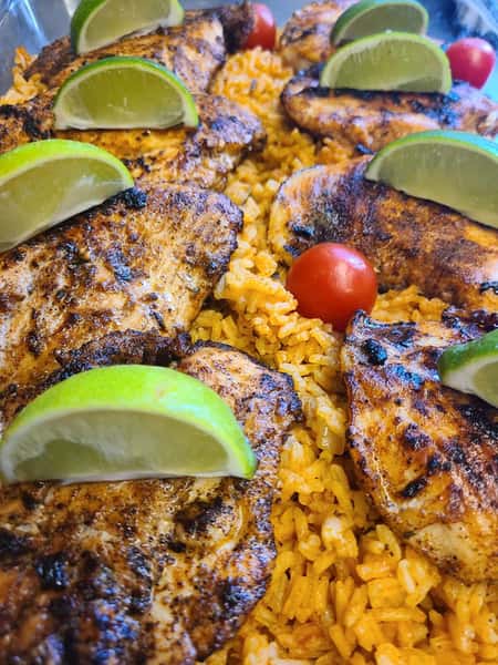 roasted chicken over rice with lime and tomato