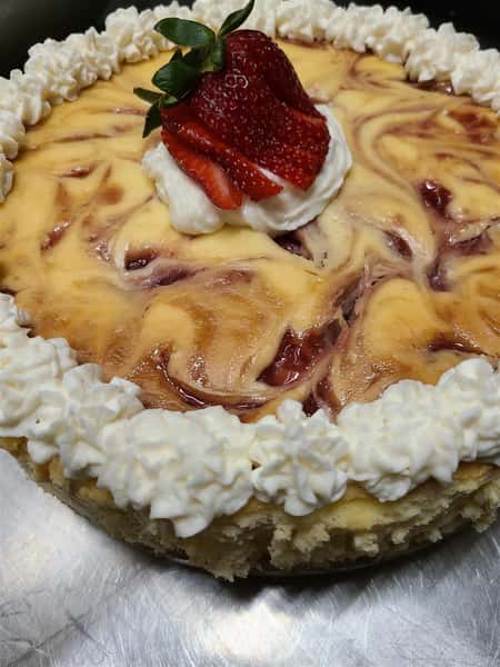 creme cake with sliced strawberry on top