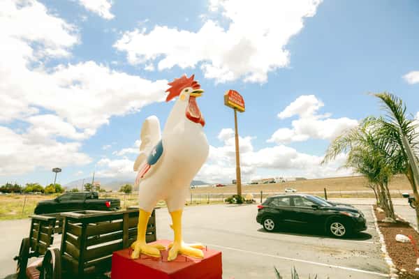 giant chicken statue in front of restaurant