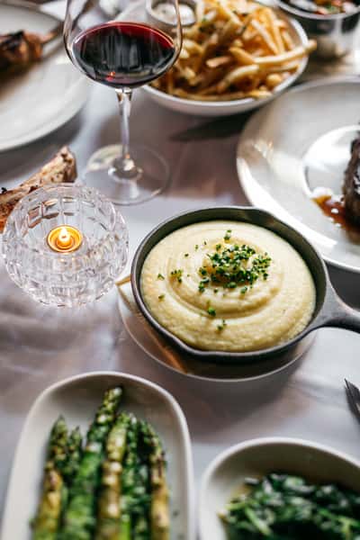spread of menu items with glass of red wine