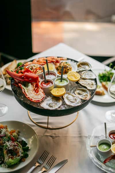 seafood platter on ice with dipping sauces
