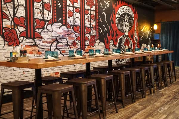 Large group bar table infront of a red and black wall mural