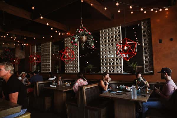 Customers enjoying comfortable booth family style dining