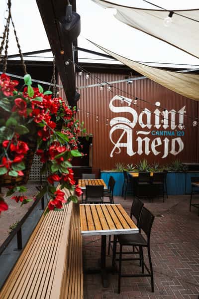 Outdoor patio dining adorned with seasonal flowers and greenery