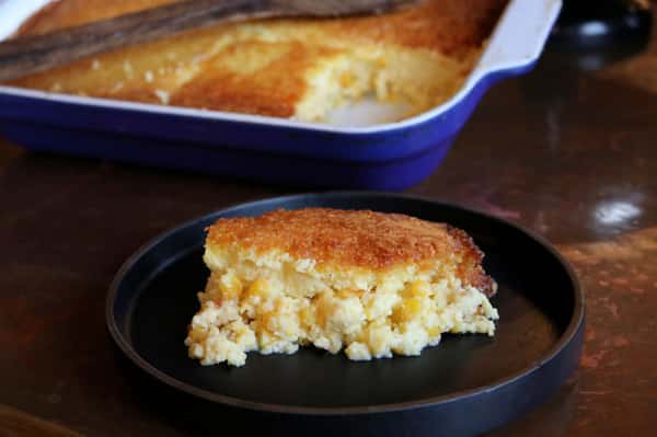 Warm homemade cornbread at Hugo's restaurant with a golden crust and moist interior, served fresh as a Southern comfort food favorite.