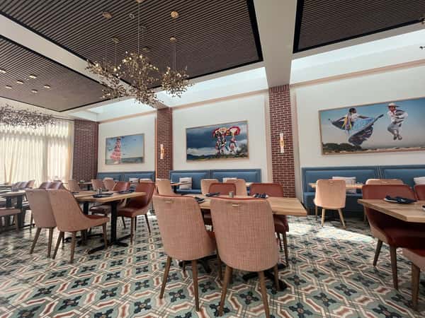 Upscale dining room at Hugo's restaurant featuring elegant seating, modern artwork, and a warm, welcoming atmosphere.