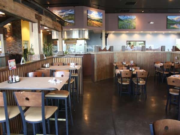 Interior dining area with kitchen in the background