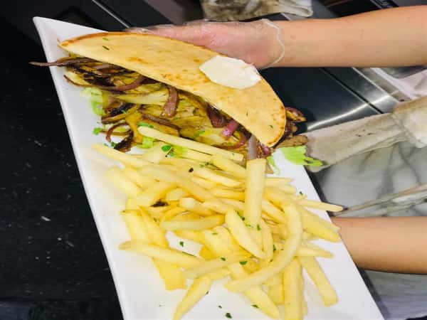 gryo pita sandwich with french fries