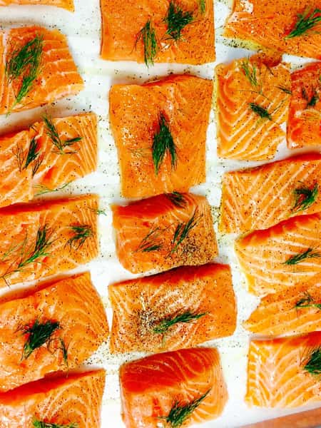 catering display of baked salmon topped with dill