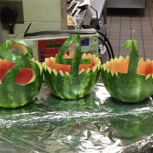 Three watermelons carved out, each with one number to spell out 841.