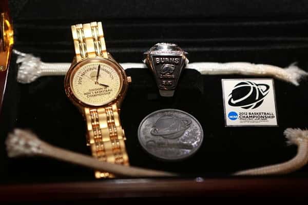 Close up of University of Wisconsin Basketball Champions memorabilia box with a watch and ring inside.