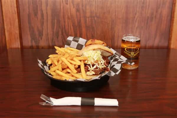 Brew House Specialty Sandwich topped with coleslaw with a side of french fries. Served with a red martini with a light beer.