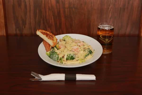 Pasta dish with a light cream sauce, mixed with broccoli and shrimp. Served with light beer.