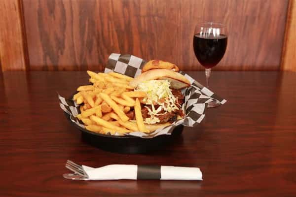 Brew House Specialty Sandwich topped with coleslaw with a side of french fries. Served with a red martini with a glass of red wine.