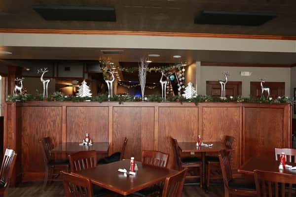 Inside of restaurant with winter decorations and garland.