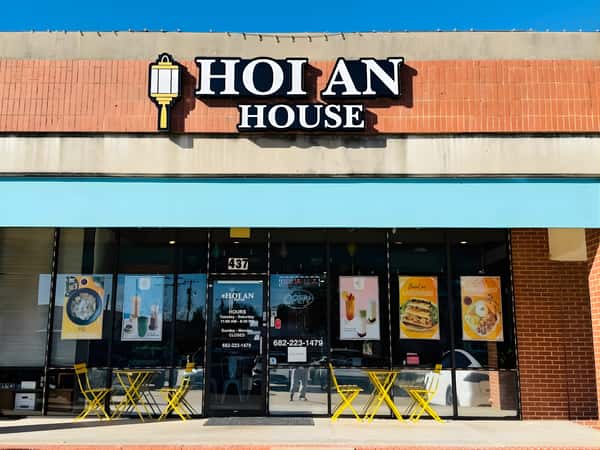 Storefront exterior with a sign reading "HOI AN HOUSE" above the entrance and outdoor seating.